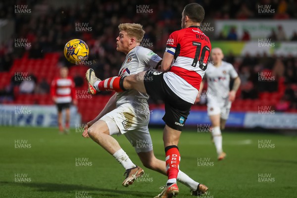 130124 - Doncaster Rovers v Newport County - Sky Bet League 2 - Will Evans of Newport reaches the ball ahead of a Doncaster defender