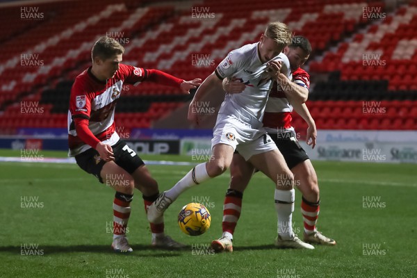 130124 - Doncaster Rovers v Newport County - Sky Bet League 2 - Harry Charsley of Newport shields the ball
