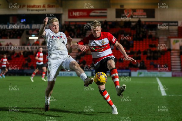 130124 - Doncaster Rovers v Newport County - Sky Bet League 2 - Will Evans of Newport competes for the ball