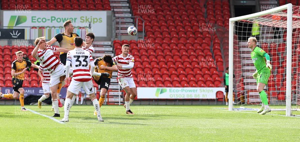 220423 - Doncaster Rovers v Newport County - Sky Bet League 2 - Cameron Norman of Newport County heads in the 3rd goal