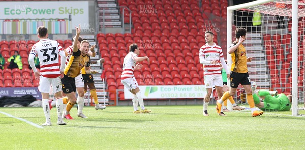 220423 - Doncaster Rovers v Newport County - Sky Bet League 2 - Cameron Norman of Newport County heads in the 3rd goal and celebrates
