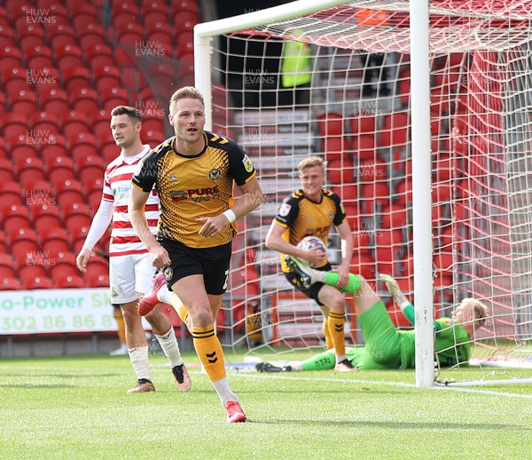 220423 - Doncaster Rovers v Newport County - Sky Bet League 2 - Cameron Norman of Newport County celebrates scoring the 3rd goal leaving Goalkeeper Jonathan Mitchell of Doncaster Rovers floored