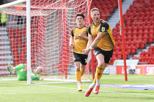 220423 - Doncaster Rovers v Newport County - Sky Bet League 2 - Cameron Norman of Newport County celebrates scoring the 3rd goal leaving Goalkeeper Jonathan Mitchell of Doncaster Rovers floored and practising his golf swing