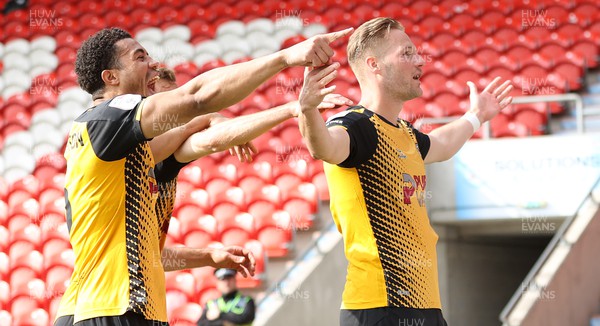 220423 - Doncaster Rovers v Newport County - Sky Bet League 2 - Cameron Norman of Newport County celebrates scoring the 3rd goal with Priestley Farquharson and Mickey Demetriou