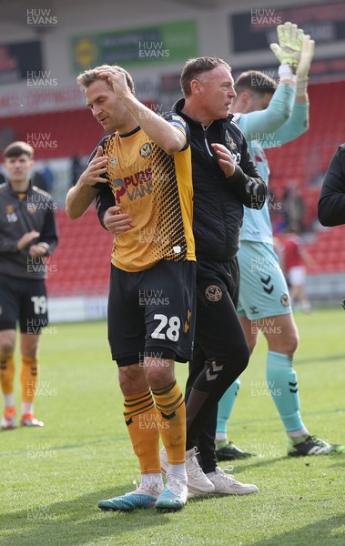 220423 - Doncaster Rovers v Newport County - Sky Bet League 2 - Manager Graham Coughlan of Newport County hugs Mickey Demetriou of Newport County at the end of the match