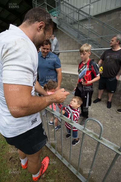 270821 - Dragons Open Training Session at Abertillery BG RFC - Jamie Roberts signs autographs for fans after an open training session in front of supporters at Abertillery Park