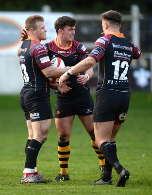 221016 - Dragons Premiership Select v Ealing - British & Irish Cup -Barney Nightingale of Dragons Premiership Select celebrates his first try with Owen Davies and Connor Edwards