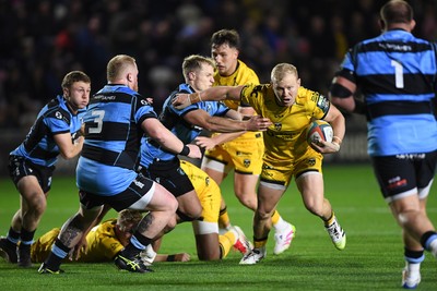 171025 - Dragons RFC v Cardiff Rugby - United Rugby Championship - Tinus De Beer of Dragons is challenged by Aled Davies of Cardiff