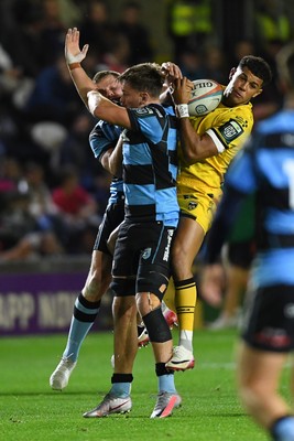 171025 - Dragons RFC v Cardiff Rugby - United Rugby Championship - Rio Dyer of Dragons is challenged by Alex Mann of Cardiff Rugby