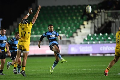 171025 - Dragons RFC v Cardiff Rugby - United Rugby Championship - Ben Thomas of Cardiff Rugby kicks the ball away from Rodrigo Martinez of Dragons
