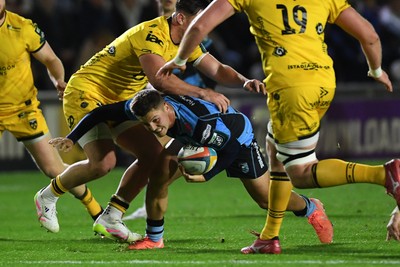 171025 - Dragons RFC v Cardiff Rugby - United Rugby Championship - Callum Sheedy of Cardiff Rugby is challenged by Harri Ackerman of Dragons