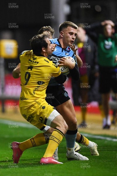 171025 - Dragons RFC v Cardiff Rugby - United Rugby Championship - Cam Winnett of Cardiff Rugby is challenged by Rhodri Williams of Dragons
