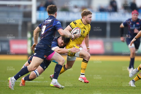 090526 - Dragons RFC v Edinburgh Rugby - United Rugby Championship - Angus O'Brien of Dragons is challenged by Hector Patterson of Edinburgh