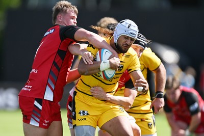 050926 - Dragons RFC v Hartpury, Preseason Friendly - Anzelo Tu’itavuki of Dragons is challenged by Harrison Bellmay of Hartpury