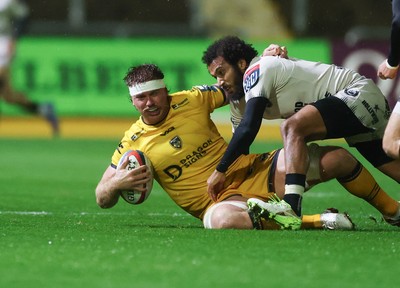 031025 - Dragons RFC v Hollywoodbets Sharks, United Rugby Championship - Aaron Wainwright of Dragons is tackled by Jaden Hendrikse of Hollywoodbets Sharks