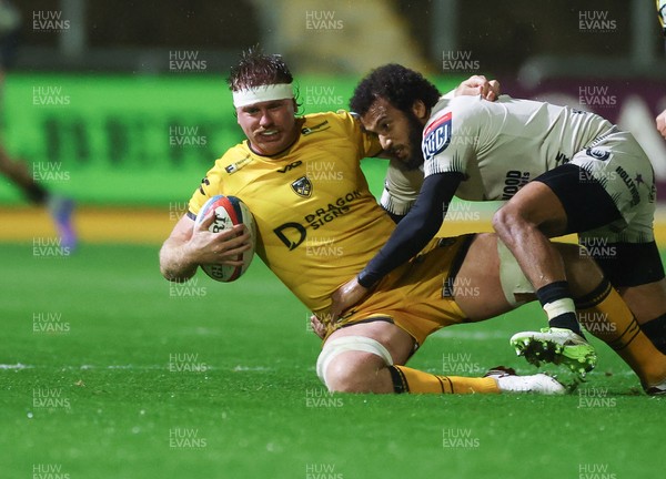 031025 - Dragons RFC v Hollywoodbets Sharks, United Rugby Championship - Aaron Wainwright of Dragons is tackled by Jaden Hendrikse of Hollywoodbets Sharks