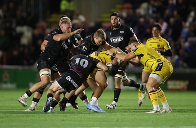 091026 - Dragons RFC v Ospreys - United Rugby Championship - Fetuli Paea of Dragons is tackled by Keiran Williams and Dan Edwards of Ospreys 
