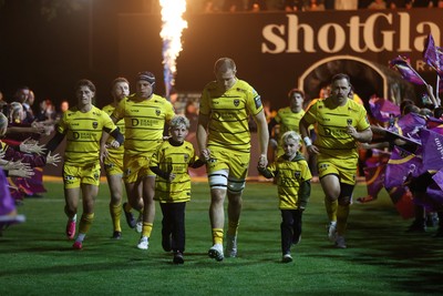 091026 - Dragons RFC v Ospreys - United Rugby Championship - Ben Carter of Dragons runs out with the mascots