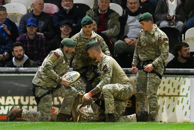 091026 - Dragons RFC v Ospreys - United Rugby Championship - Royal Marines deliver match ball from Rodney Parade roof