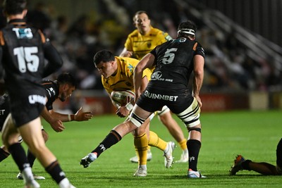 091026 - Dragons RFC v Ospreys - United Rugby Championship - Chris Coleman of Dragons is challenged by Ryan Smith of Ospreys