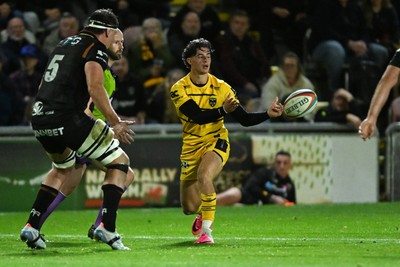 091026 - Dragons RFC v Ospreys - United Rugby Championship - Che Hope of Dragons is challenged by Ryan Smith of Ospreys