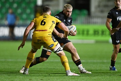 091026 - Dragons RFC v Ospreys - United Rugby Championship - Gareth Thomas of Ospreys is challenged by Shane Lewis-Hughes of Dragons