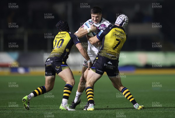 181123 - Dragons RFC v Ospreys - United Rugby Championship - Max Nagy of Ospreys is tackled by Will Reed and Ollie Griffiths of Dragons 