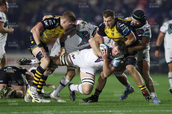 181123 - Dragons RFC v Ospreys - United Rugby Championship - James Ratti of Ospreys is tackled by Matthew Screech and Ben Carter of Dragons 