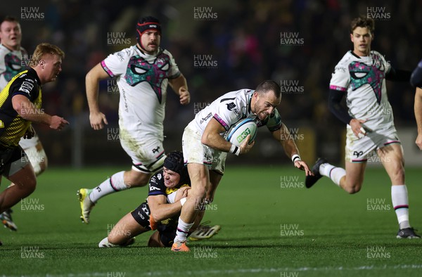 181123 - Dragons RFC v Ospreys - United Rugby Championship - Luke Morgan of Ospreys is tackled by Will Reed of Dragons 