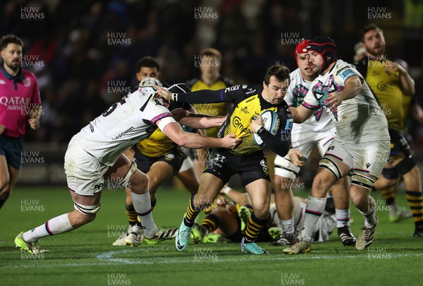 181123 - Dragons RFC v Ospreys - United Rugby Championship - Rhodri Williams of Dragons is tackled by Adam Beard of Ospreys 