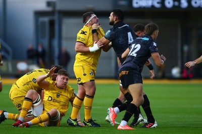 251025 - Dragons RFC v Ospreys - United Rugby Championship - Wyn Jones of Dragons and Rhys Davies of Ospreys square up during a heated exchange