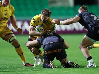 251025 - Newport RFC v Ospreys, United Rugby Championship - Thomas Young of Dragons takes on Ryan Smith of Ospreys