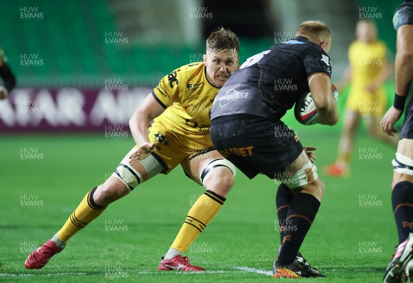 251025 - Newport RFC v Ospreys, United Rugby Championship - Matthew Screech of Dragons takes on Huw Sutton of Ospreys 