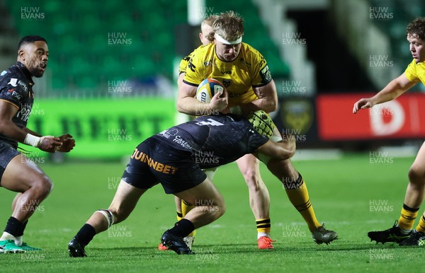 251025 - Newport RFC v Ospreys, United Rugby Championship - Aaron Wainwright of Dragons takes on Harri Deaves of Ospreys