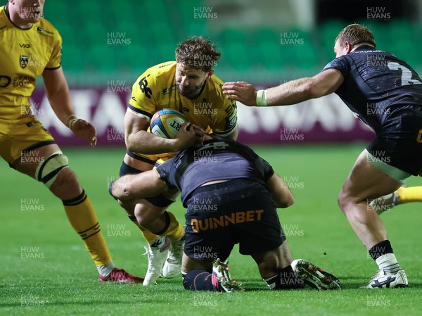 251025 - Newport RFC v Ospreys, United Rugby Championship - Thomas Young of Dragons takes on Ryan Smith of Ospreys