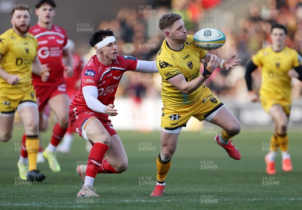 010126 - Dragons RFC v Scarlets - United Rugby Championship - Angus O'Brien of Dragons is tackled by Tom Rogers of Scarlets 