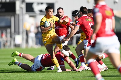 031026 - Dragons RFC v Scarlets - United Rugby Championship - Rio Dyer of Dragons is challenged by Kemsley Mathias of Scarlets