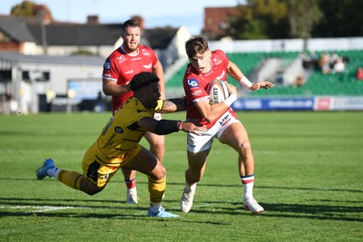 031026 - Dragons RFC v Scarlets - United Rugby Championship - Johnny Williams of Scarlets runs in to score a try