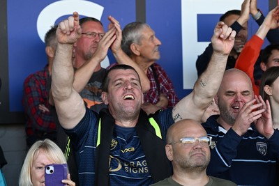 031026 - Dragons RFC v Scarlets - United Rugby Championship - Dragons fans celebrate the win at full time