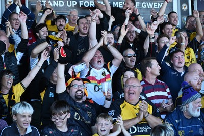 031026 - Dragons RFC v Scarlets - United Rugby Championship - Dragons fans celebrate the win at full time