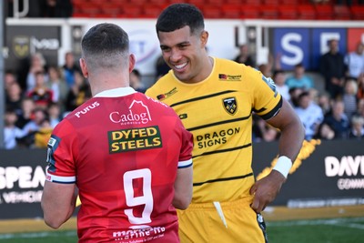 031026 - Dragons RFC v Scarlets - United Rugby Championship - Dane Blacker of Scarlets and Rio Dyer of Dragons at full time