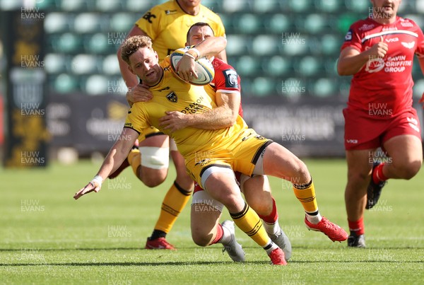 130925 - Dragons RFC v Scarlets - Pre Season Friendly - Angus O�Brien of Dragons is tackled by Gareth Davies of Scarlets 