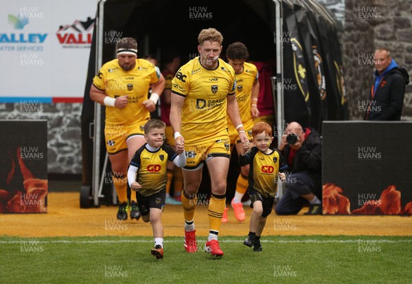 130925 - Dragons RFC v Scarlets - Pre Season Friendly - Angus O�Brien of Dragons runs out with the mascots