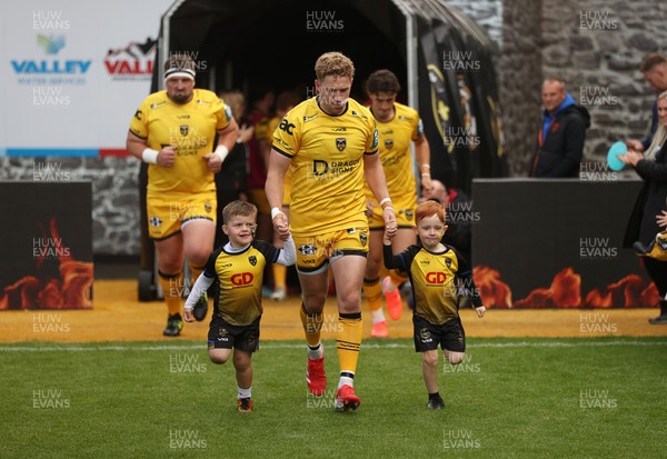 130925 - Dragons RFC v Scarlets - Pre Season Friendly - Angus O�Brien of Dragons runs out with the mascots