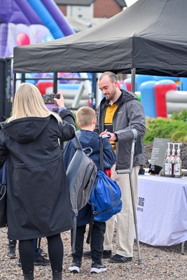 220325 - Dragons RFC v Ulster - United Rugby Championship - An injured Cai Evans of Dragons Rugby meeting fans in the fan zone before kick off