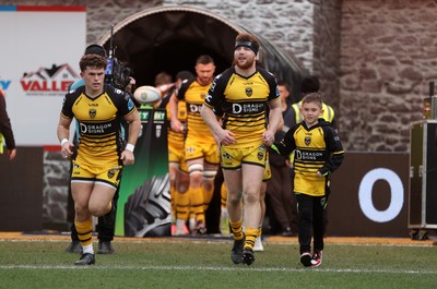 220325 - Dragons RFC v Ulster - United Rugby Championship - Aneurin Owen of Dragons runs out with mascot