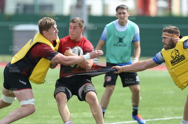070819 - Dragons Training Session - Huw Taylor is held by Harri Keddie during Dragons training session