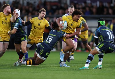 280226 - Dragons RFC v Benetton Rugby - United Rugby Championship - Fine Inisi of Dragons is tackled by Paolo Odogwu of Benetton Rugby 