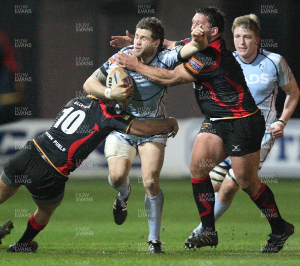 150312 -  Newport Gwent Dragons v Cardiff Blues, RaboDirect PRO12 - Blues Gavin Evans is tackled by Dragons Lewis Robling and Dragons Nathan Williams    