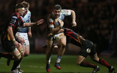 261213 - Newport Gwent Dragons v Cardiff Blues, RaboDirect PRO12 - Blues' Dafydd Hewitt is tackled by Dragons Wayne Evans